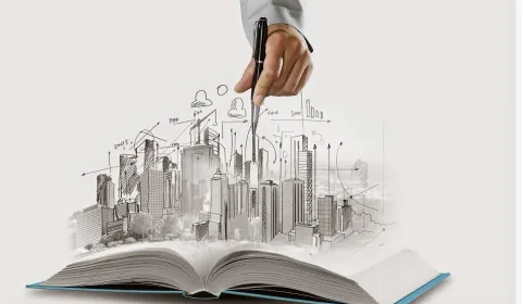A city skyline sketch rising from an open book, representing corporate growth