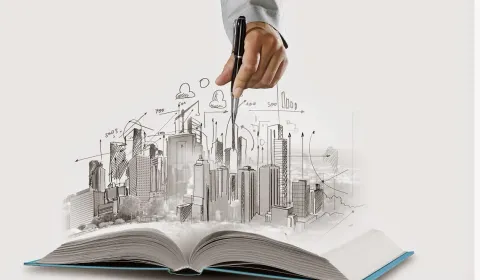 A city skyline sketch rising from an open book, representing corporate growth